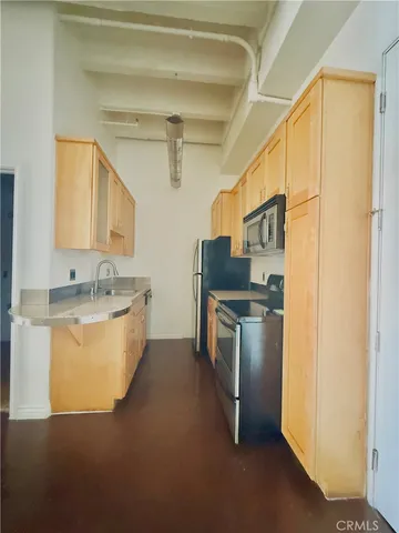 a kitchen with a sink appliances and cabinets