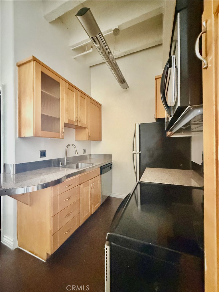 312 West 5th Street, Unit 903 Los Angeles, CA 90013 - Photo 10 of 12 a kitchen with a sink appliances and cabinets