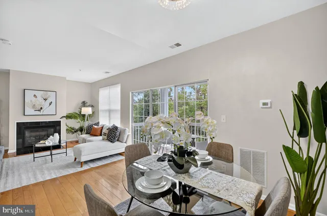 a living room with furniture a fireplace and a potted plant