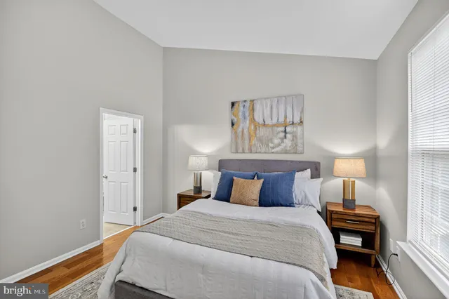 a bedroom with a bed and a window