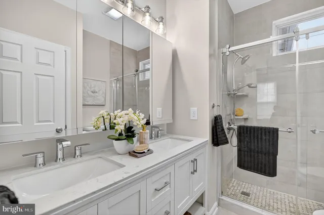 a bathroom with a double vanity sink and a mirror