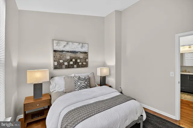 a bedroom with a bed and a lamp on table