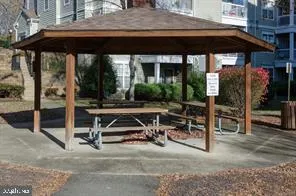a view of a patio with table and chairs under an umbrella