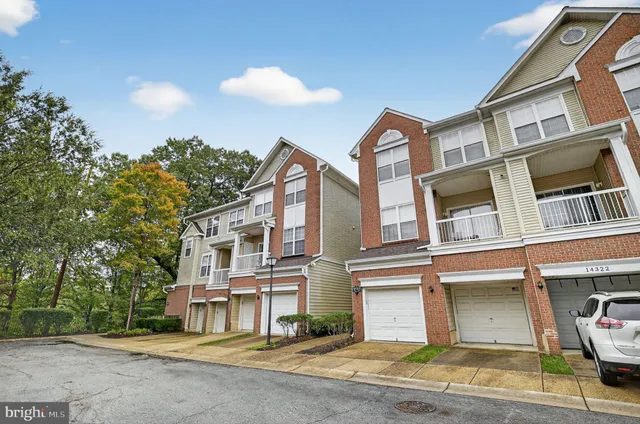 a front view of a residential apartment building with a yard