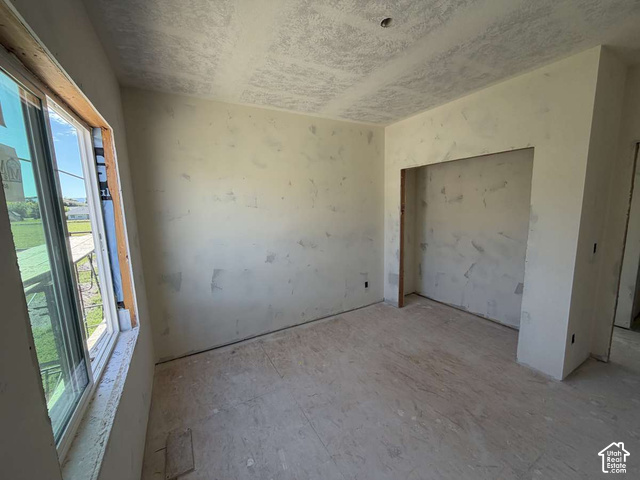 338 West 3400 South Logan, UT 84321 - Photo 40 of 40 Unfinished interior space featuring a window, built-in wall niche, and unfinished flooring