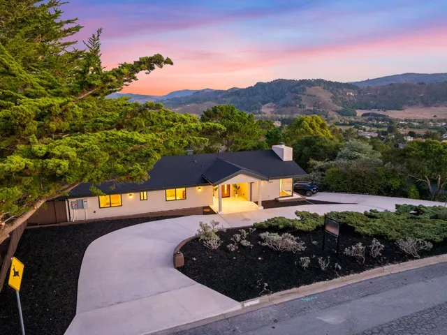 a view of a house with a yard and a garden