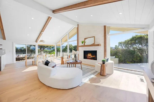 a view of a dining room with furniture large windows and wooden floor