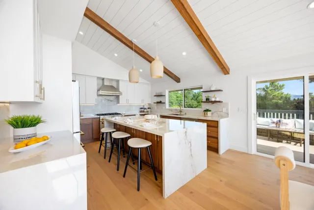 a kitchen with a sink a counter top space cabinets and stainless steel appliances