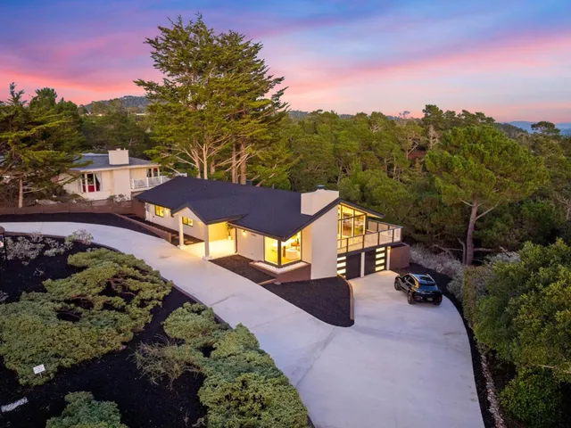 a view of a street with a houses in the background