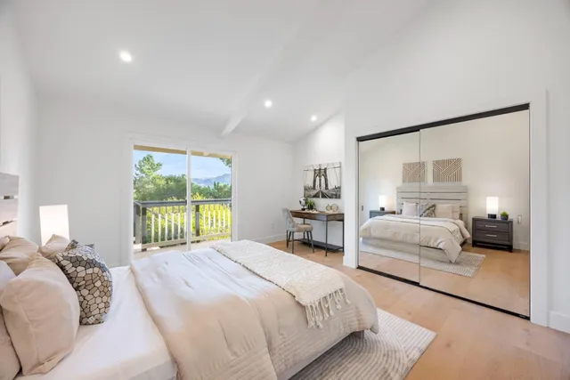 a spacious bedroom with a bed and a large window