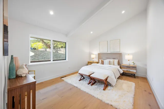 a large bathroom with a sink a toilet and a large mirror