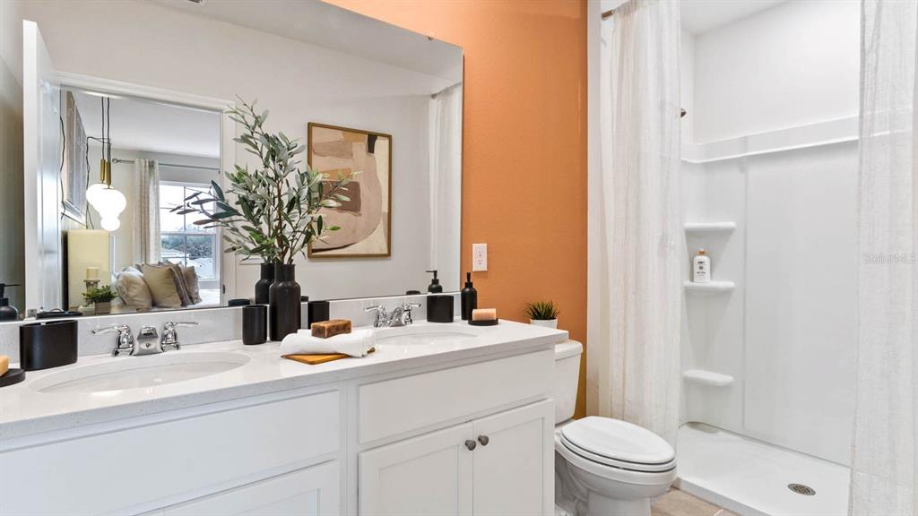 31207 Midnight Sun Way Wesley Chapel, FL 33545 - Photo 20 of 22 a bathroom with a toilet sink and mirror
