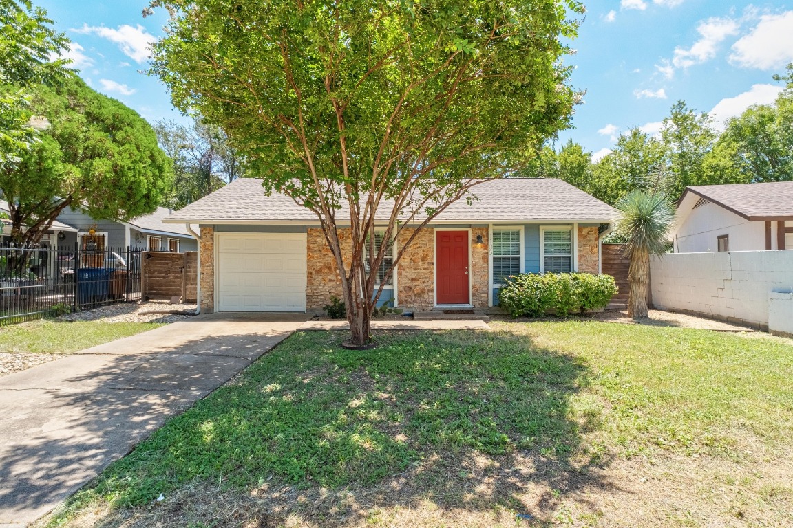 1105 Brookswood Avenue Austin, TX 78721 - Photo 1 of 1 a front view of a house with a yard and trees