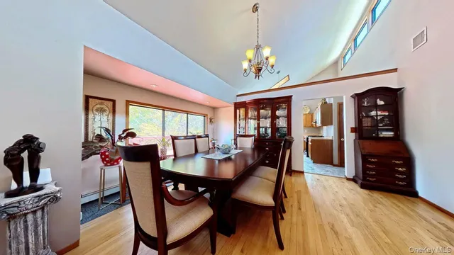 a view of a dining room with furniture and a chandelier