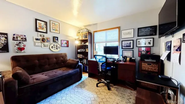 a living room with furniture workspace and a flat screen tv