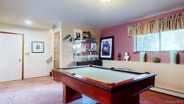 a room with pool table and windows