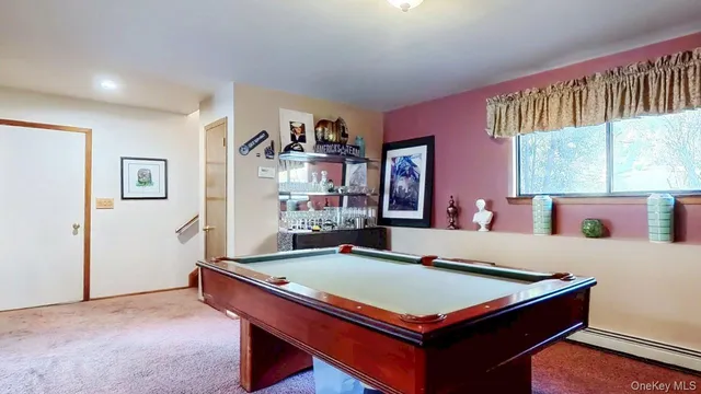 a room with pool table and windows