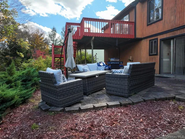 a view of a patio with couches chairs and a fire pit