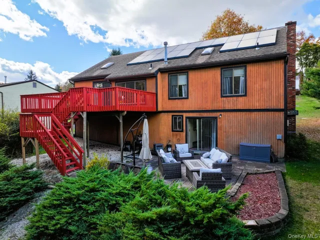 a view of a chairs and table in backyard