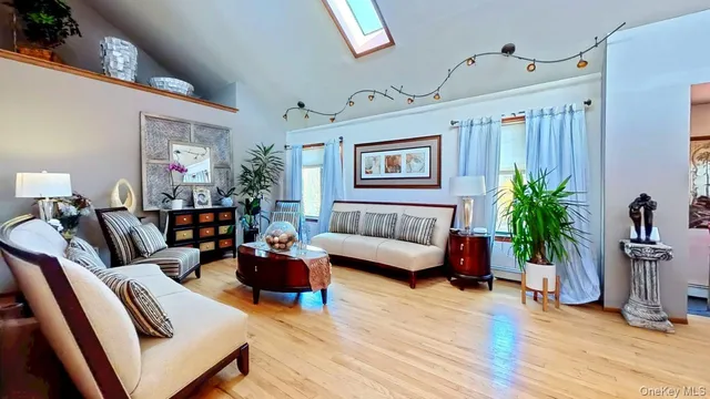 a living room with furniture and a potted plant