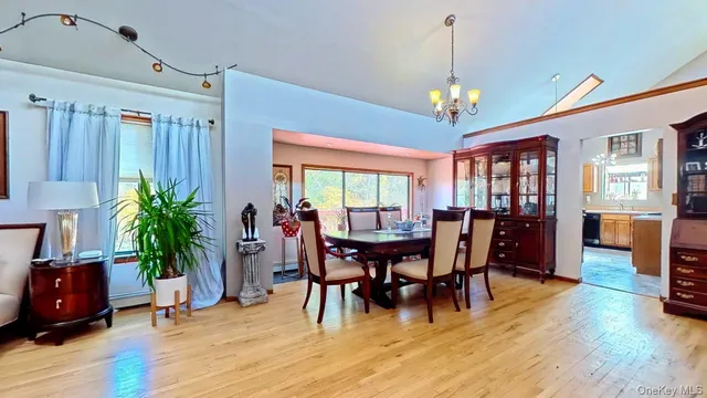 a view of a dining room with furniture window and wooden floor