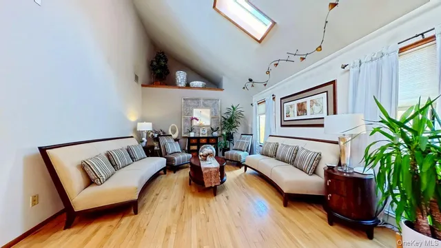 a living room with furniture and a potted plant