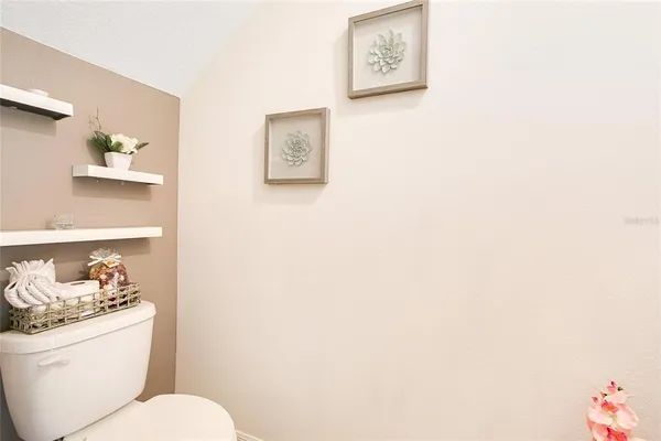 a white toilet sitting next to a bathroom sink