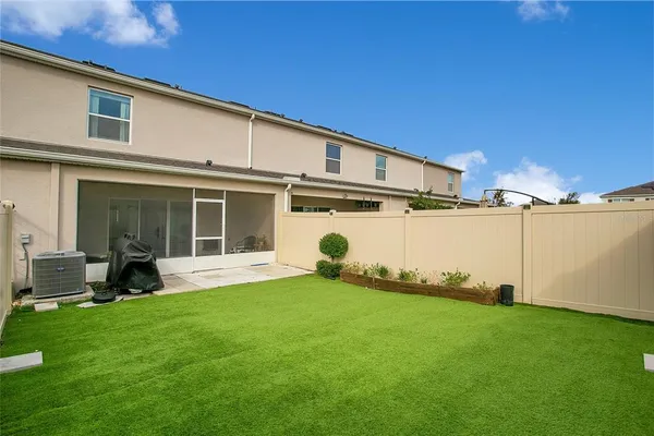 a backyard of a house with table and chairs