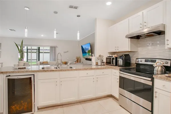 a kitchen with a sink stove and cabinets
