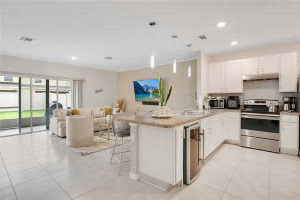 a kitchen that has a lot of cabinets in it and appliances