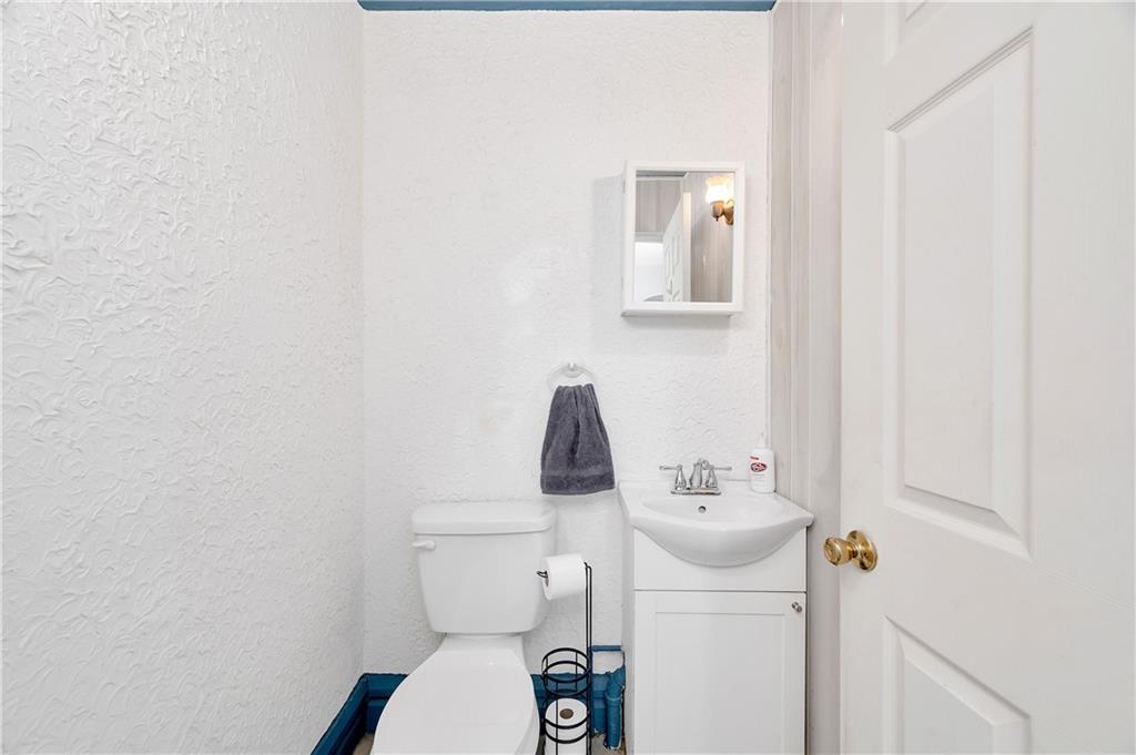 821 Vogan Street New Castle, PA 16101 - Photo 12 of 33 a bathroom with a sink a toilet and mirror