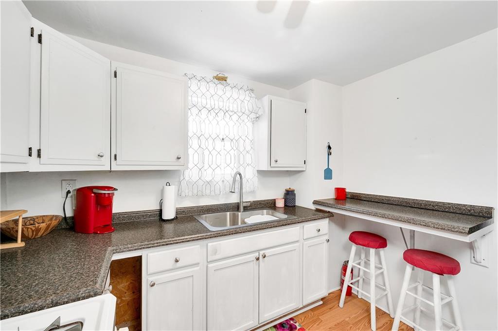 821 Vogan Street New Castle, PA 16101 - Photo 14 of 33 a kitchen with stainless steel appliances granite countertop a sink and cabinets