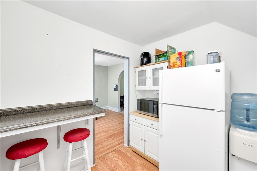 821 Vogan Street New Castle, PA 16101 - Photo 15 of 33 a kitchen with a refrigerator and a stove