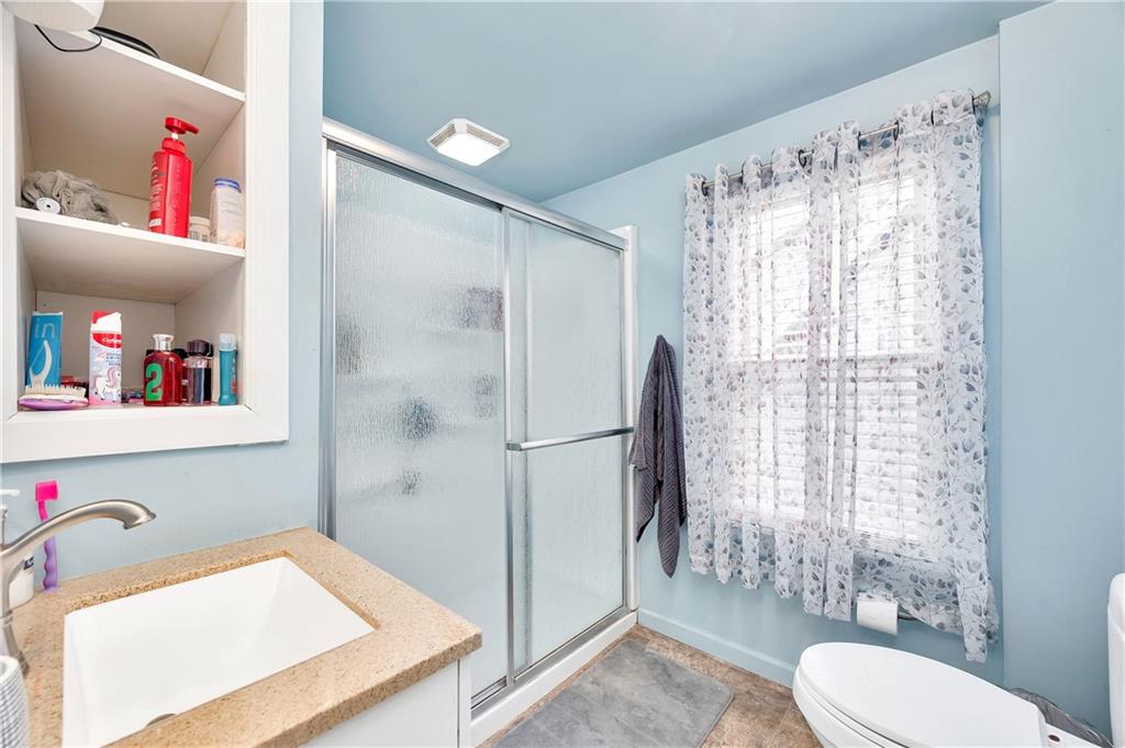 821 Vogan Street New Castle, PA 16101 - Photo 17 of 33 a bathroom with a sink toilet and shower