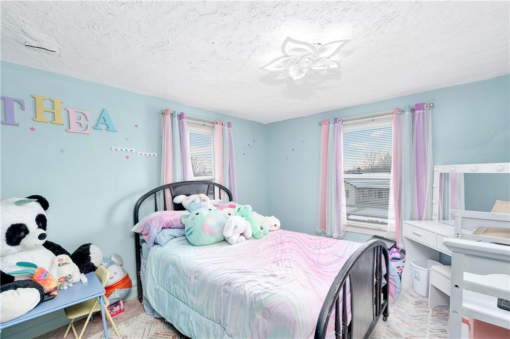 821 Vogan Street New Castle, PA 16101 - Photo 19 of 33 a bedroom with a bed and a chandelier