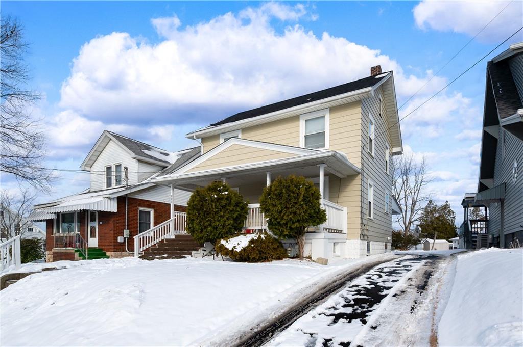 821 Vogan Street New Castle, PA 16101 - Photo 2 of 33 a front view of a house with a yard and garage