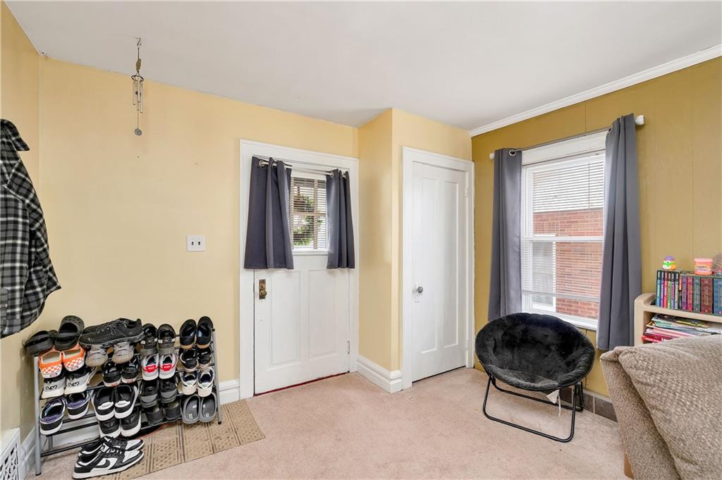 821 Vogan Street New Castle, PA 16101 - Photo 5 of 33 a bedroom with furniture and a large window