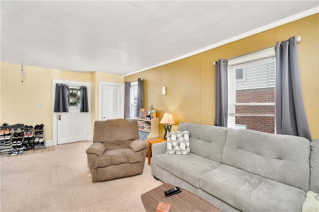 821 Vogan Street New Castle, PA 16101 - Photo 8 of 33 a living room with furniture and a window