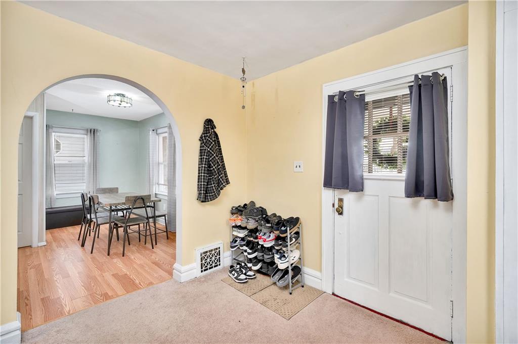 821 Vogan Street New Castle, PA 16101 - Photo 9 of 33 a view of a hallway with dining room and wooden furniture