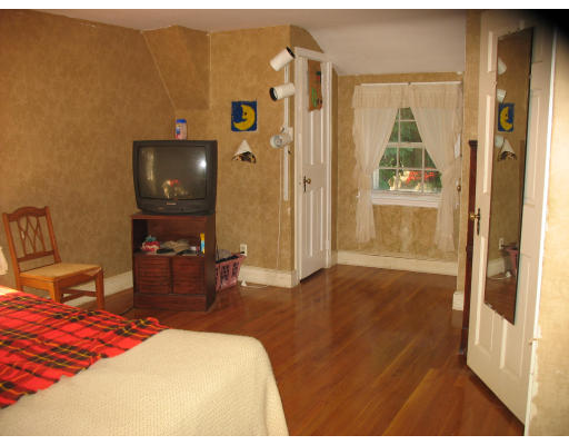 48 Nickerson Road Newton, MA 02467 - Photo 12 of 15 a bedroom with a bed and a flat tv screen on dresser