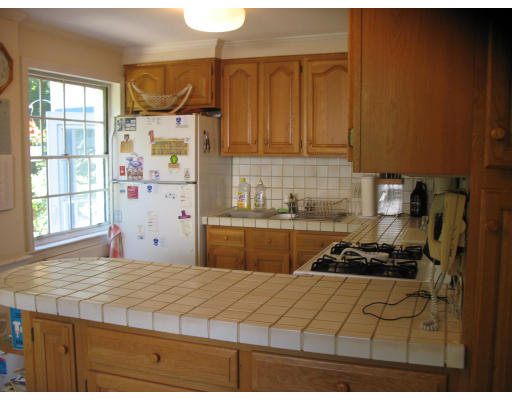 48 Nickerson Road Newton, MA 02467 - Photo 3 of 15 a kitchen with a stove a refrigerator and a window