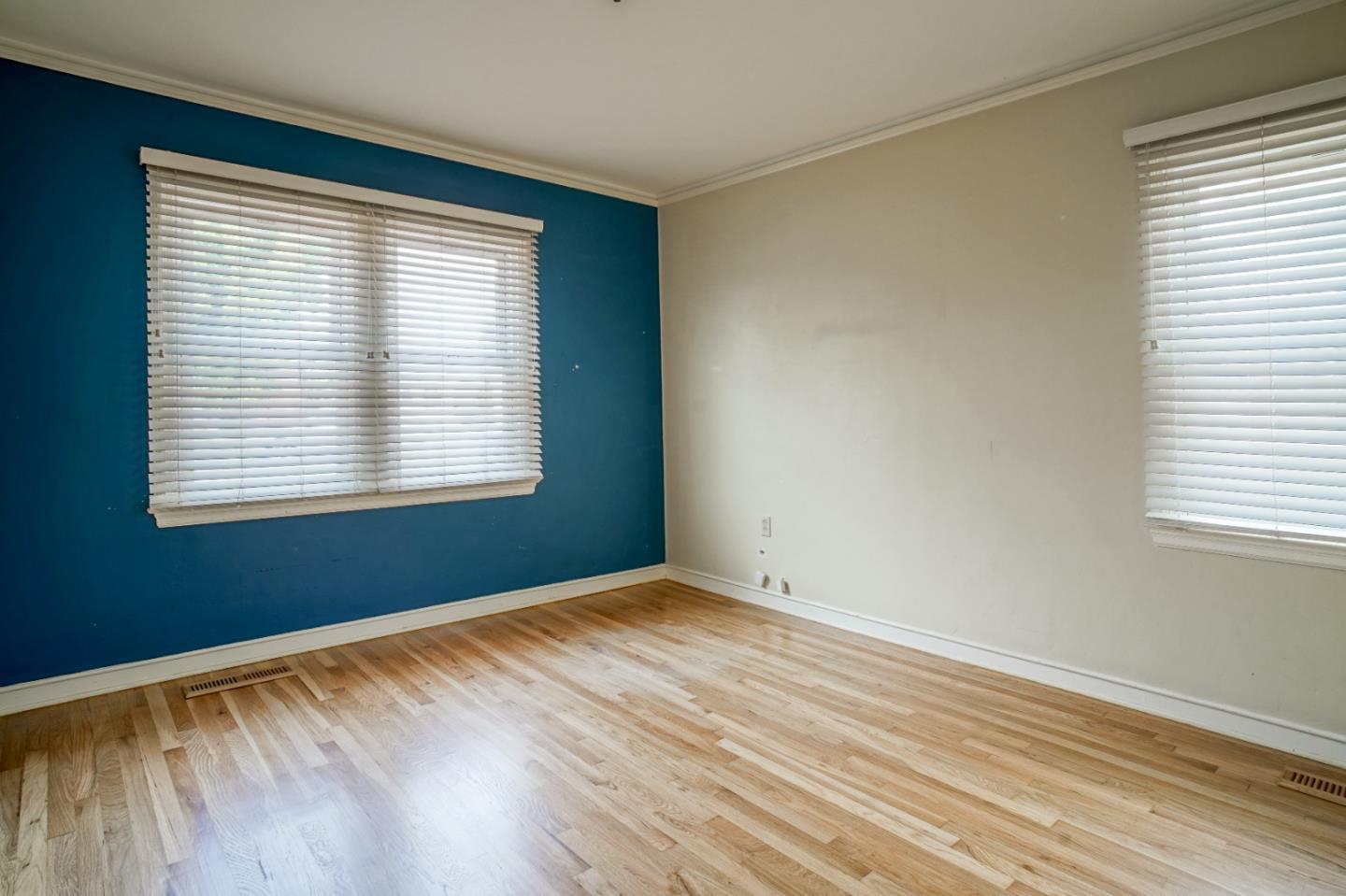 351 Lorimer Street Salinas, CA 93901 - Photo 11 of 37 a view of an empty room with wooden floor and a window