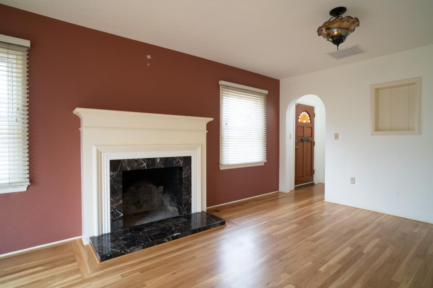 351 Lorimer Street Salinas, CA 93901 - Photo 3 of 37 a view of an empty room with wooden floor fireplace and a window