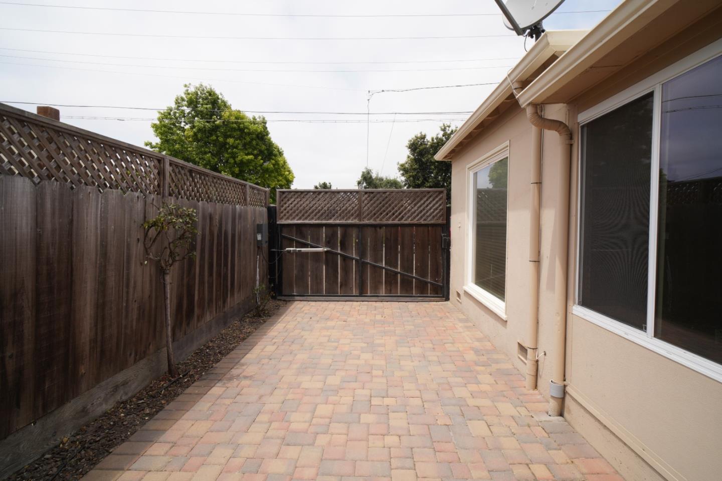 351 Lorimer Street Salinas, CA 93901 - Photo 35 of 37 a view of backyard with small cabin and wooden fencing