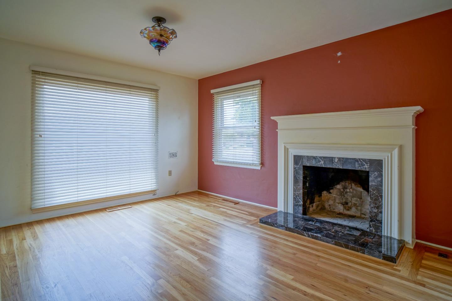 351 Lorimer Street Salinas, CA 93901 - Photo 4 of 37 a view of an empty room with wooden floor fireplace and a window