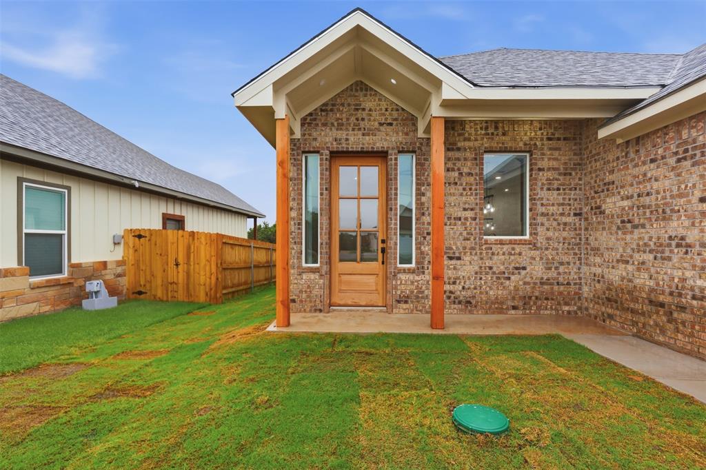 1413 Ridgeview Circle Granbury, TX 76048 - Photo 3 of 35 Brick exterior with wood-clad entry door and vertical sidelight