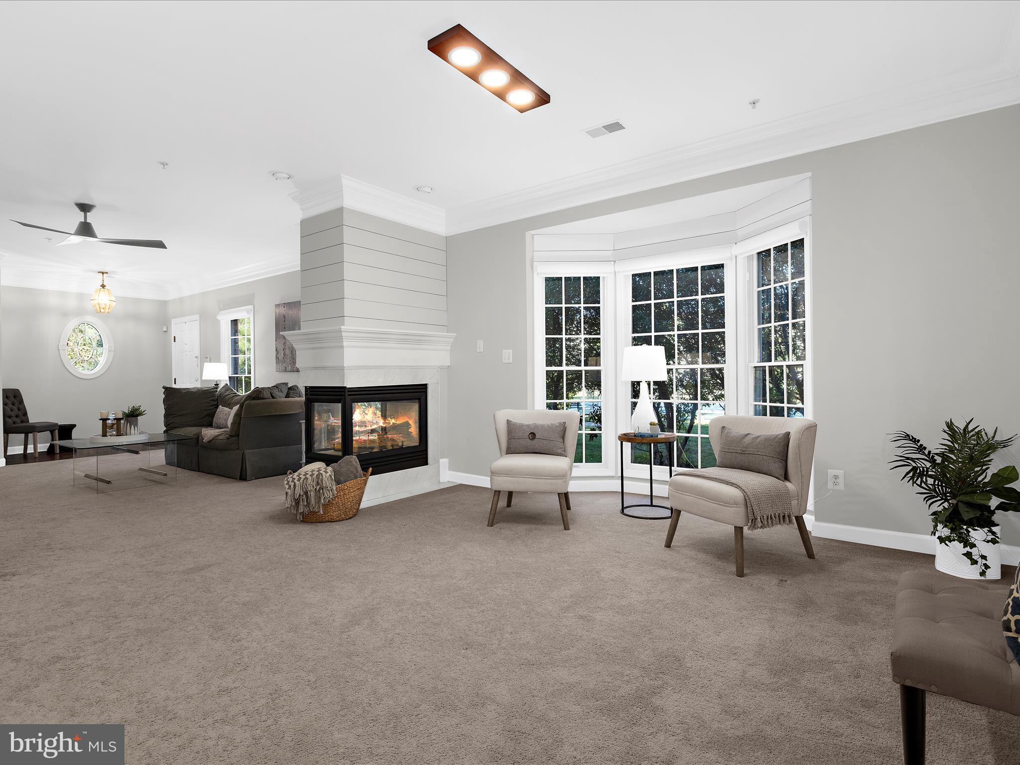 301 Colony Point Place Edgewater, MD 21037 - Photo 11 of 45 a living room with furniture and a fireplace