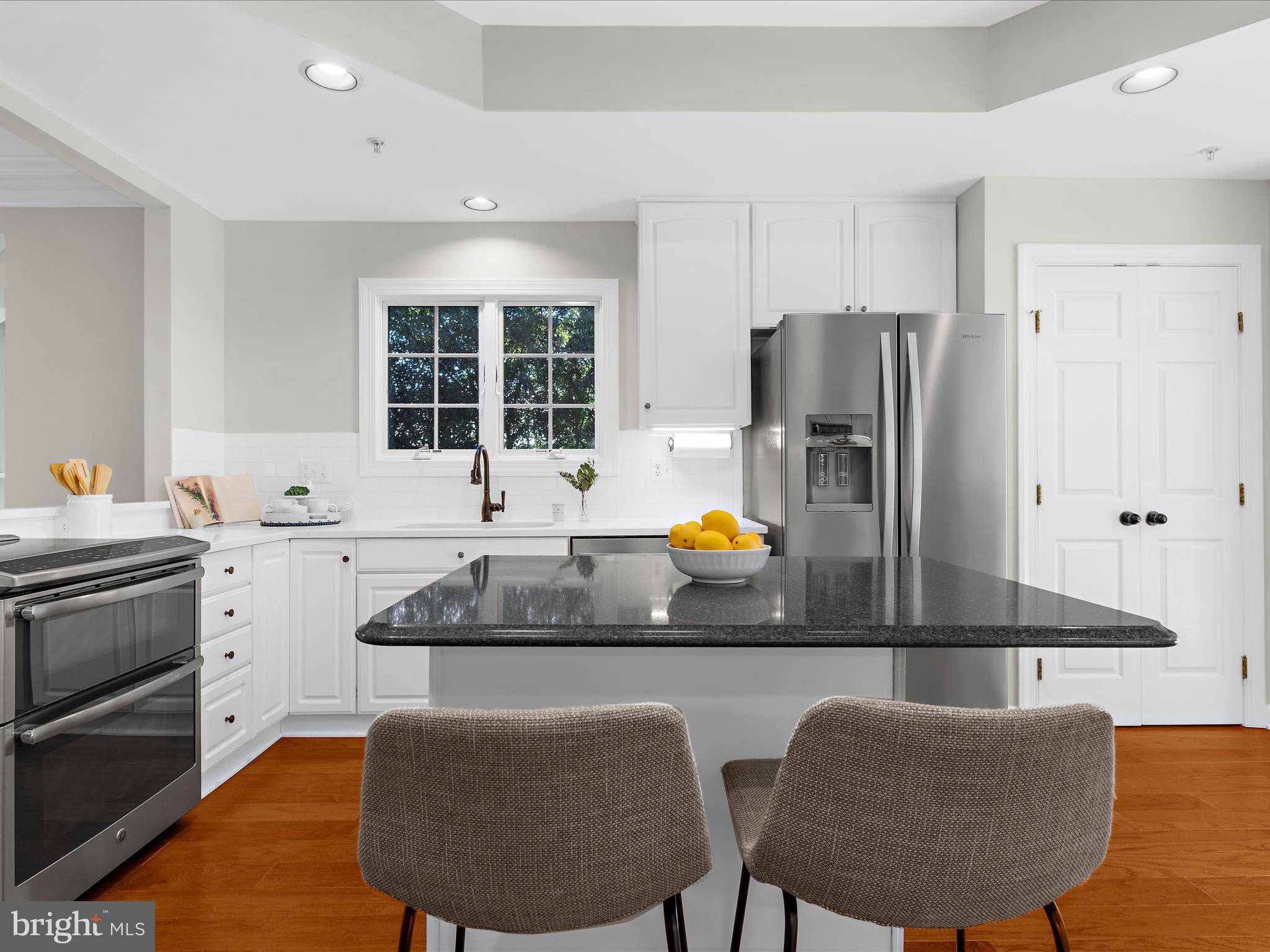 301 Colony Point Place Edgewater, MD 21037 - Photo 16 of 45 a kitchen with stainless steel appliances granite countertop a stove a refrigerator a dining table and chairs