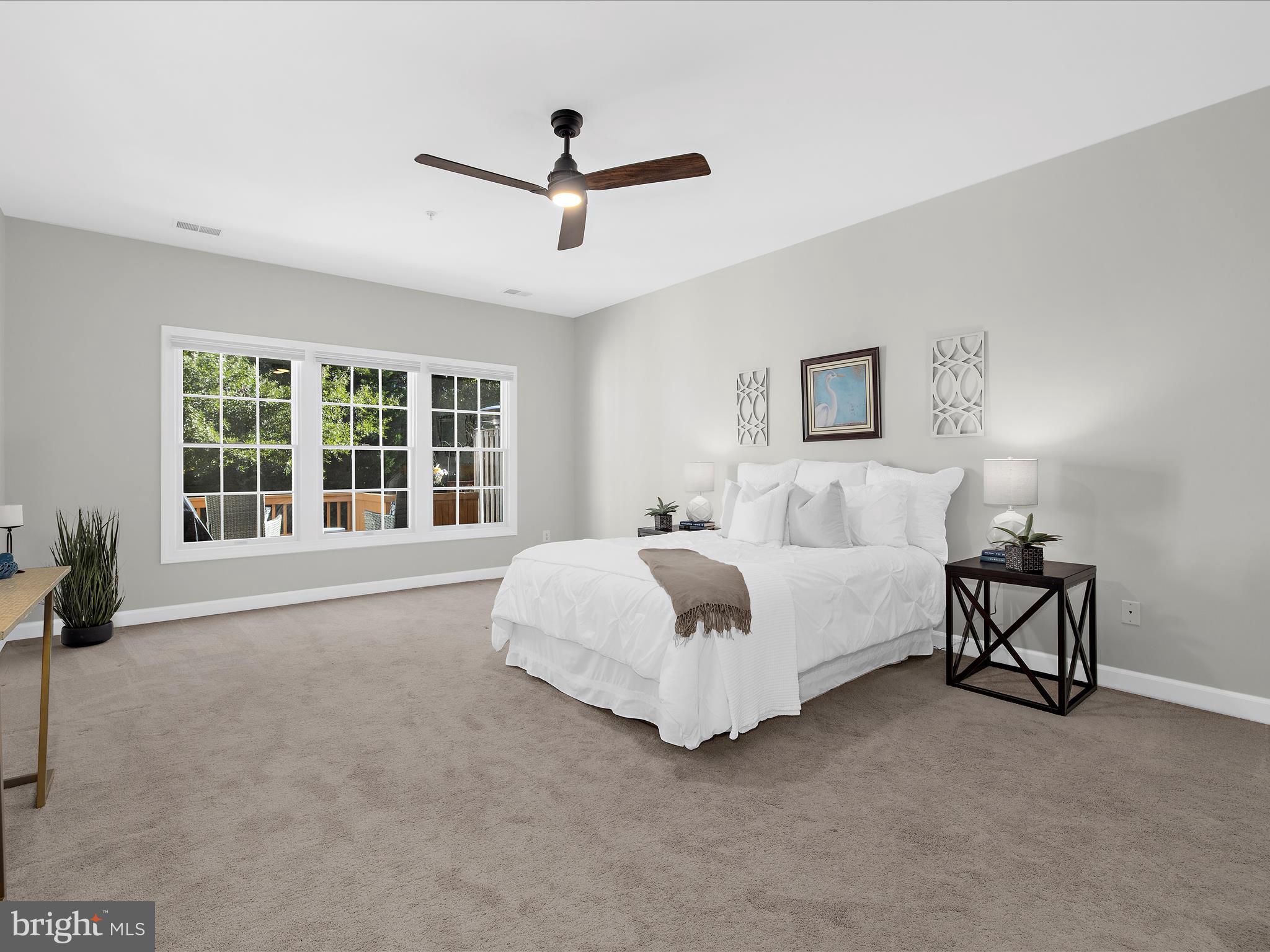 301 Colony Point Place Edgewater, MD 21037 - Photo 22 of 45 a spacious bedroom with a large bed and a large window