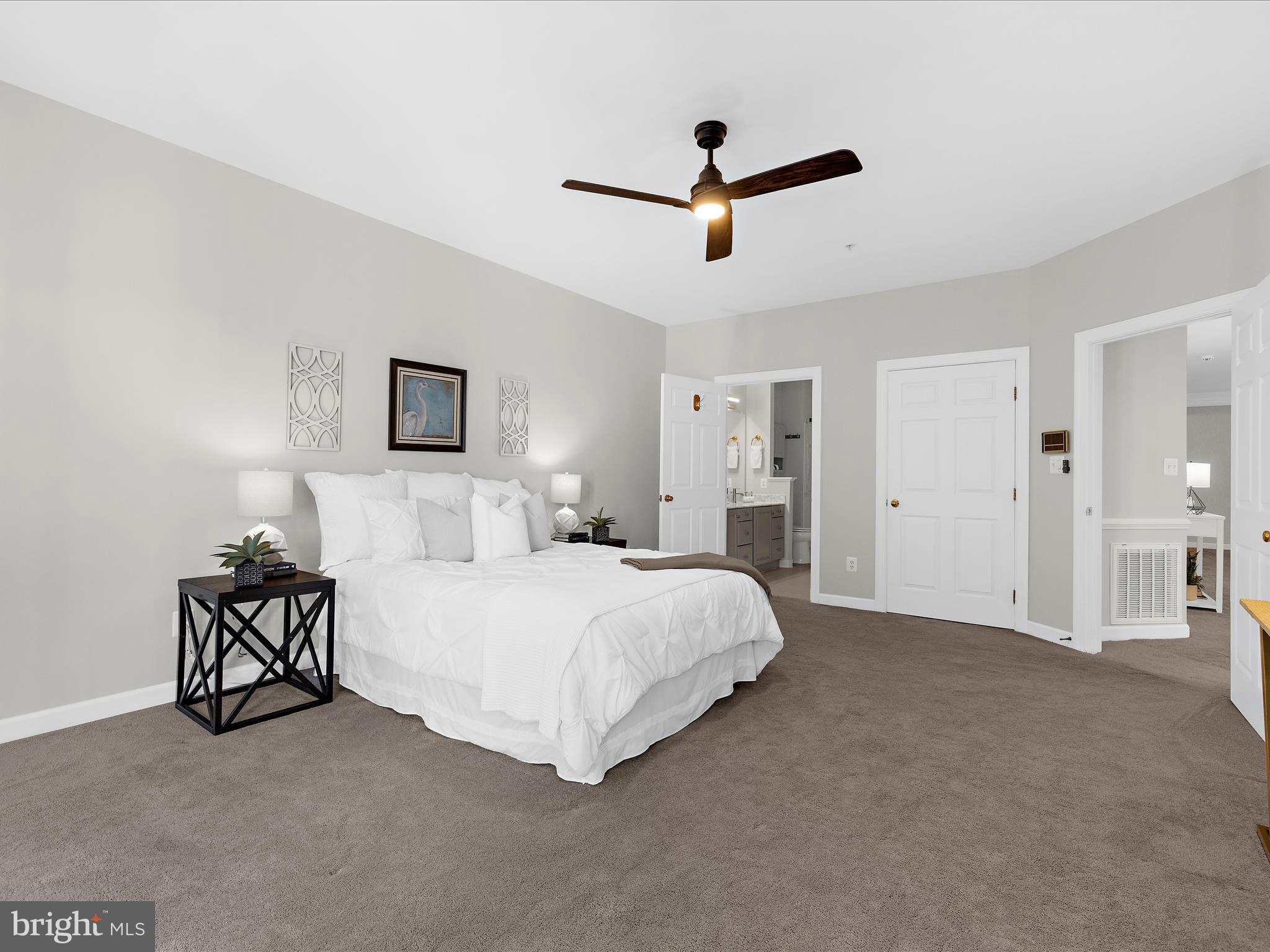 301 Colony Point Place Edgewater, MD 21037 - Photo 25 of 45 a spacious bedroom with a bed and ceiling fan